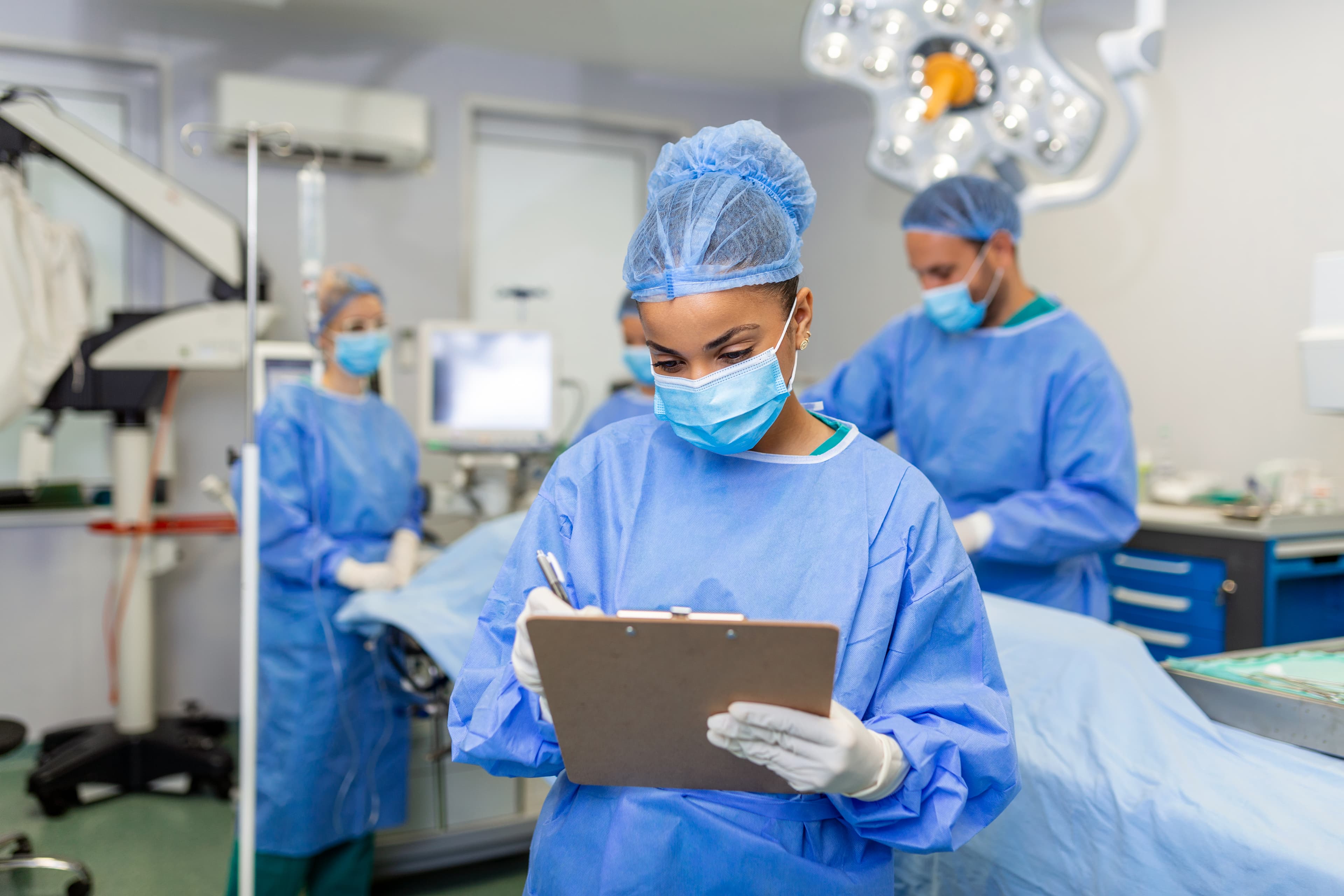 Surgeon documenting post-operative care updates on a clipboard